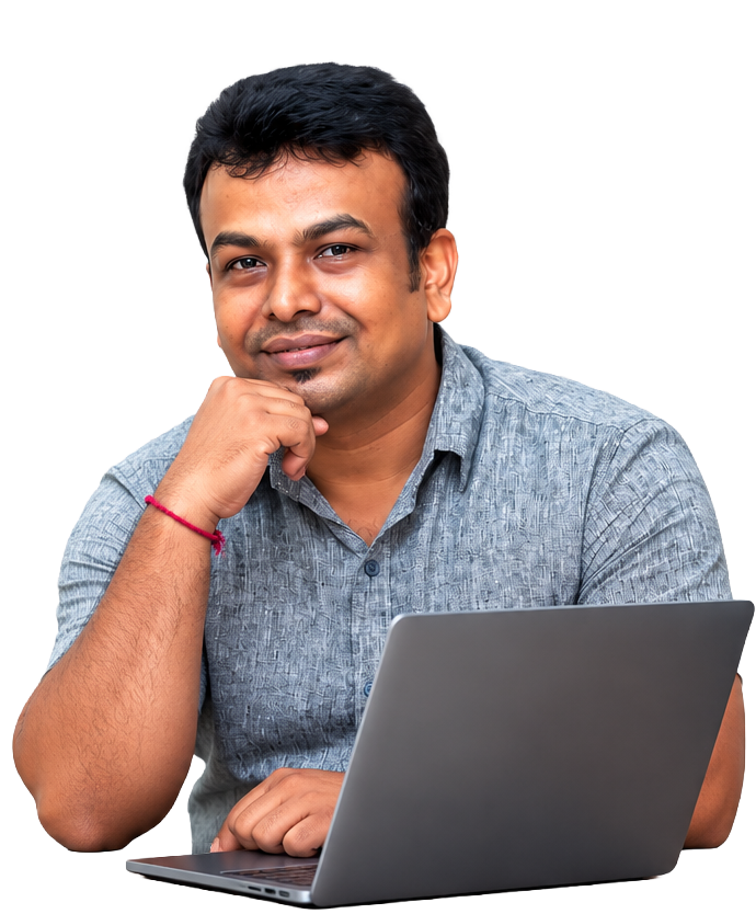 Sajeesh Subramanian smiling while working on a laptop